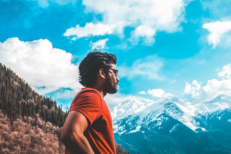 confident mountain hiker wearing sunglasses