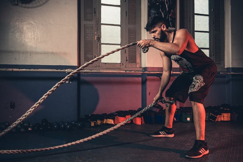 Guy doing battle ropes