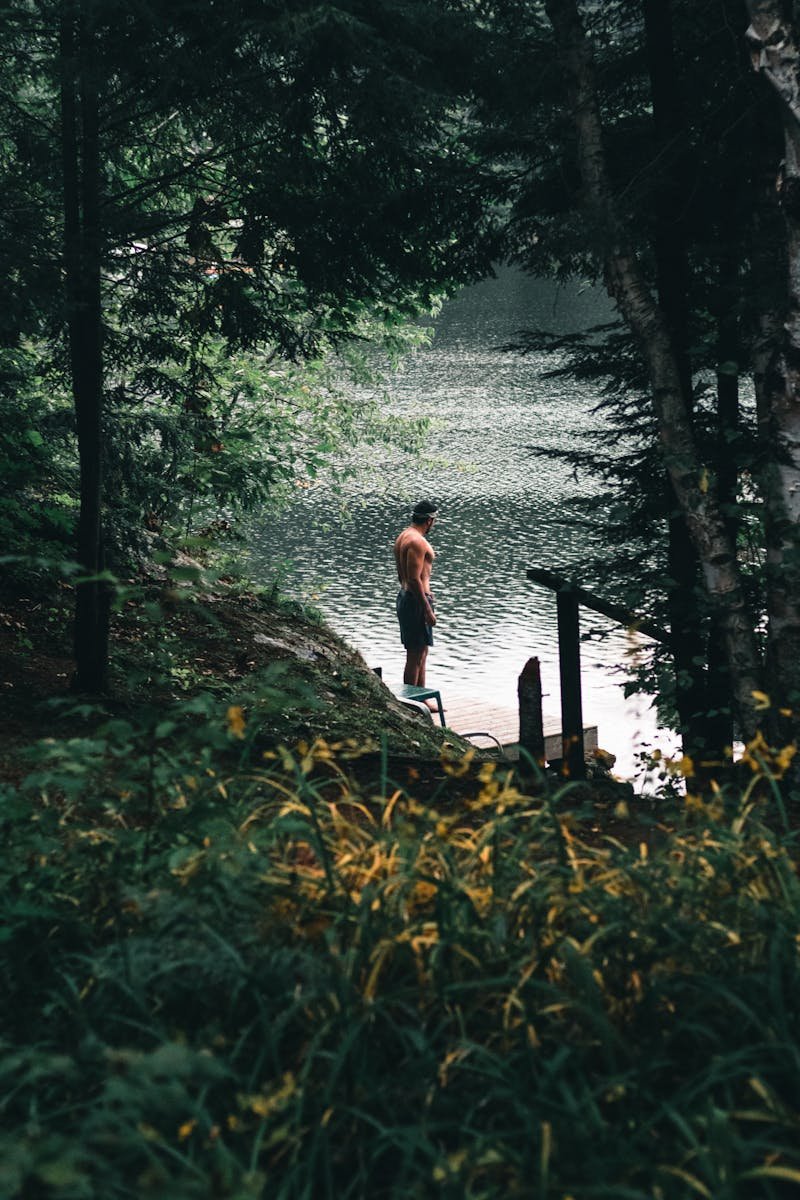 Man in forest at lake