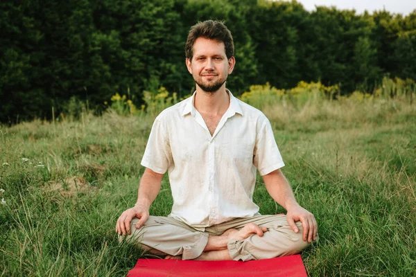 Men sitting doing yoga